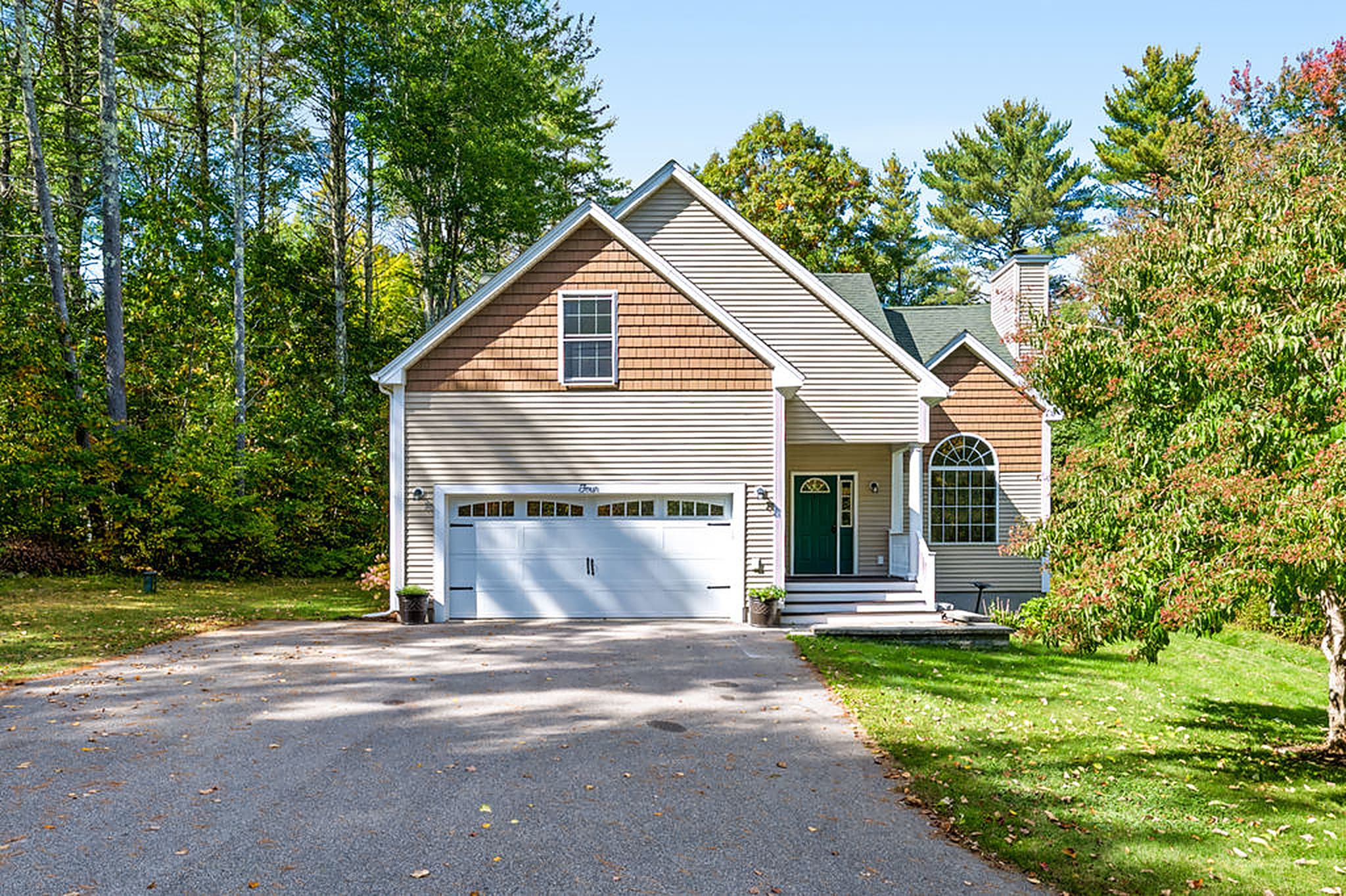 Front of the home with its two-car garage, in early fall