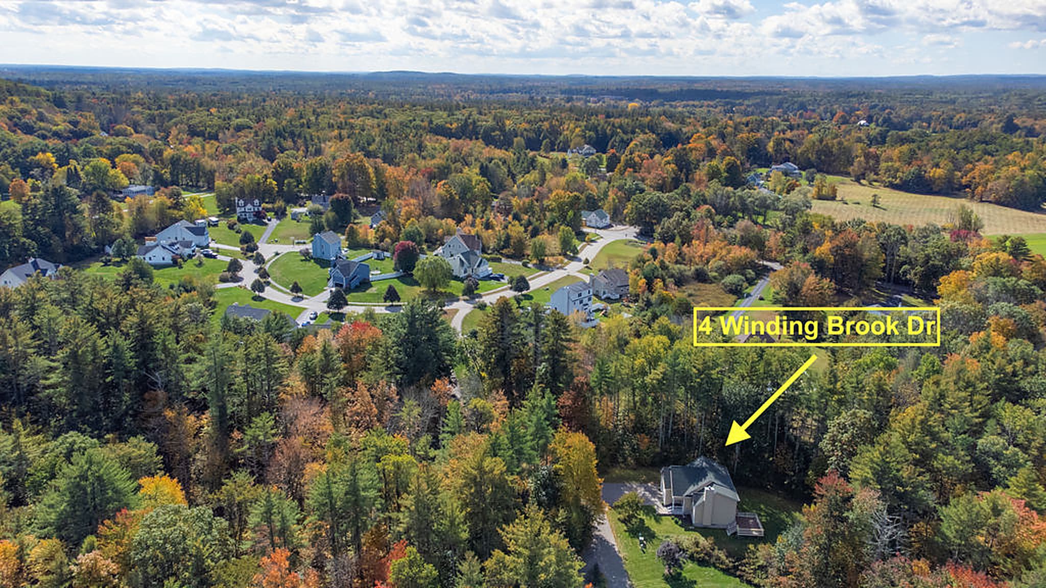 Aerial view over the woods with the home marked
